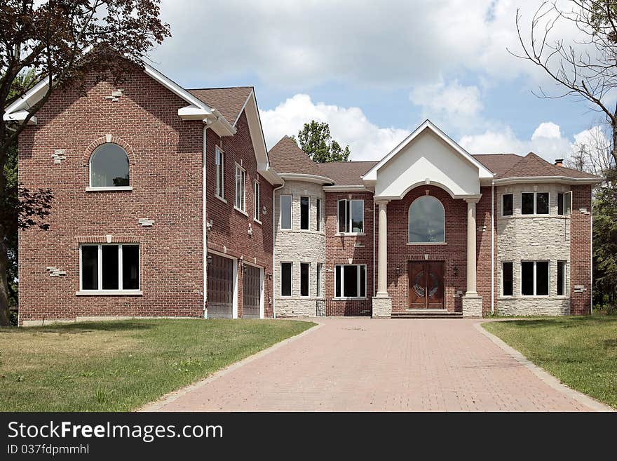 New construction brick home with arched entry