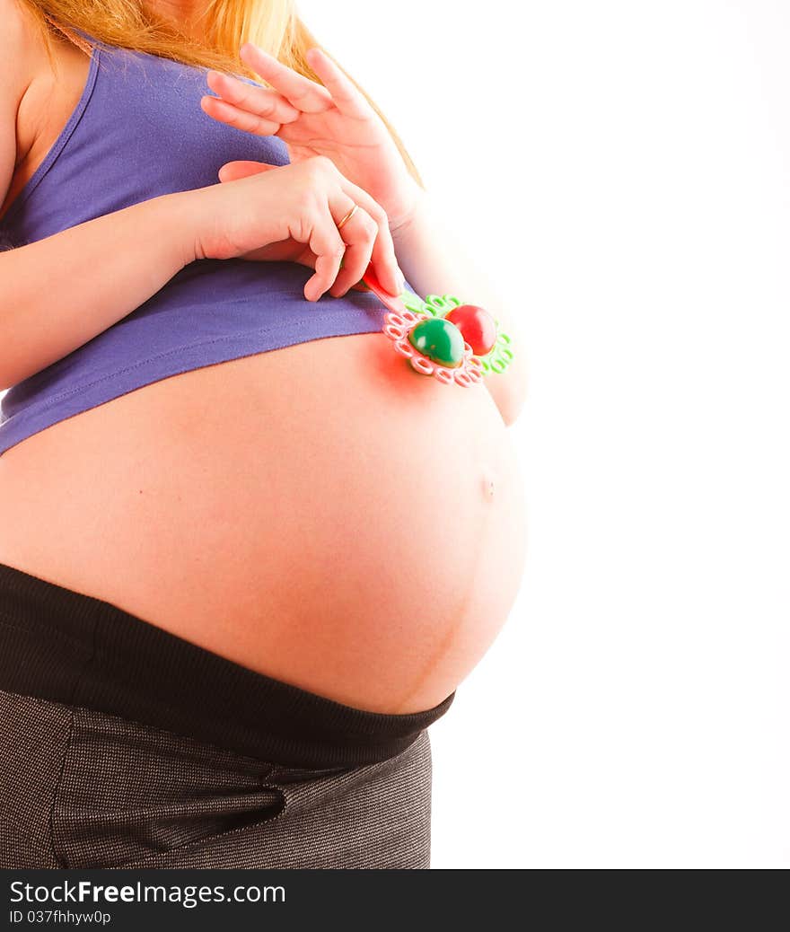 Pregnant woman holding two baby's rattle, close up. Pregnant woman holding two baby's rattle, close up