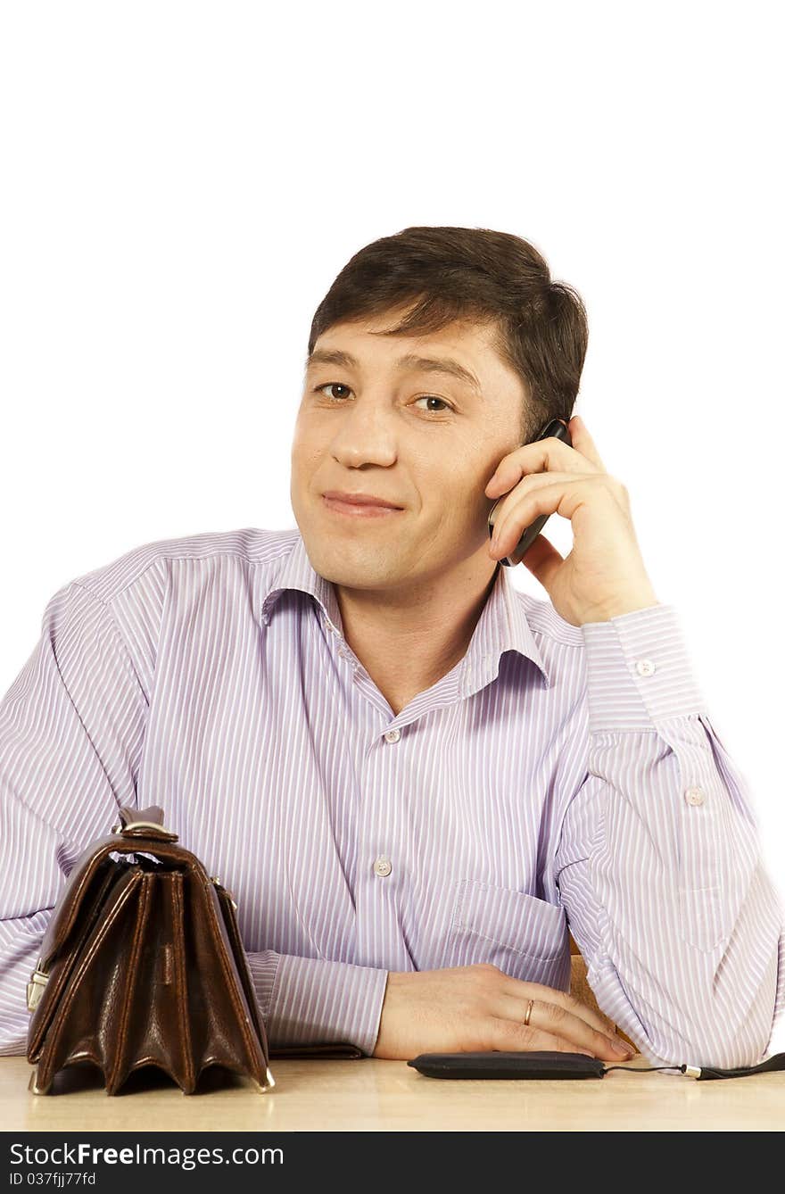 Portrait of the young man on a workplace at office. Portrait of the young man on a workplace at office