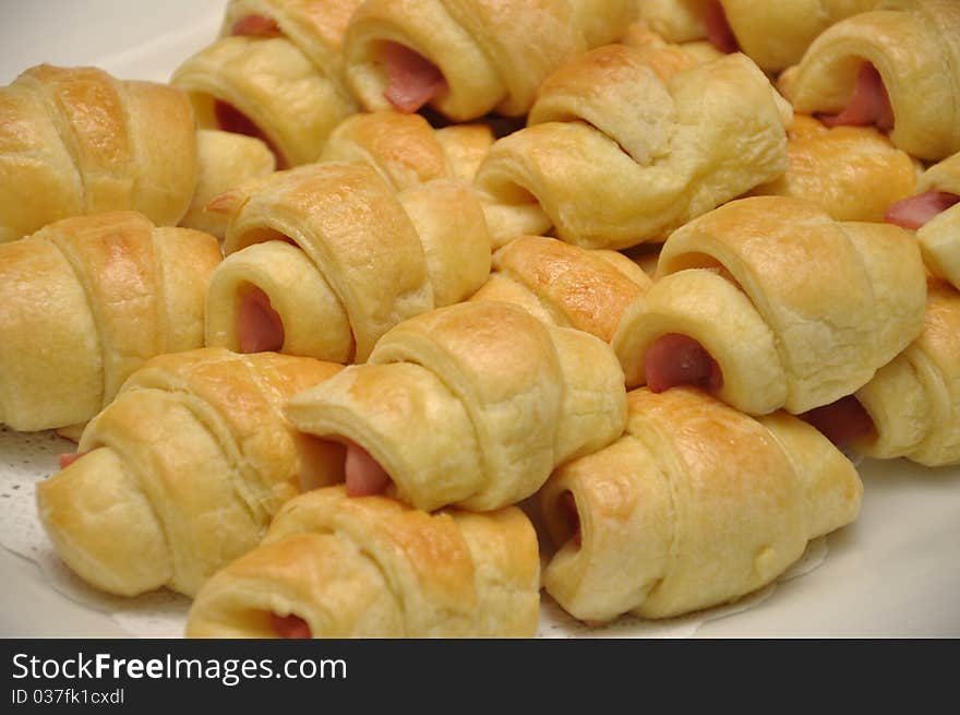 Pile of sausage rolls on a plate. Pile of sausage rolls on a plate