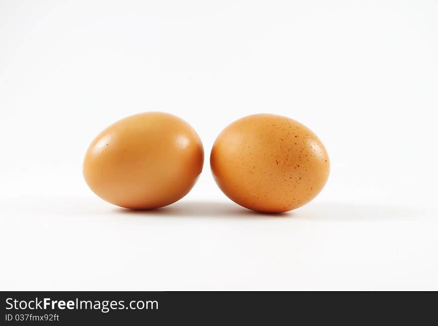 Two nice eggs lying on the isolated surface. Two nice eggs lying on the isolated surface