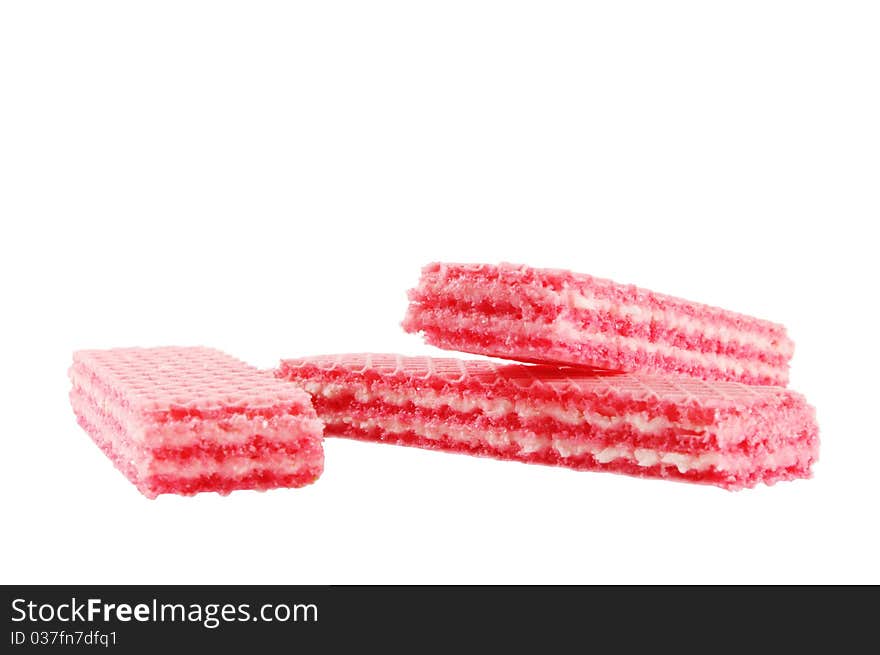 Three red strawberry wafers on white isolated surface