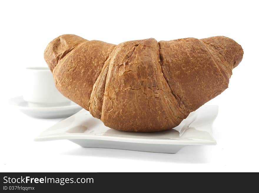 Croissant on a white plate on white background