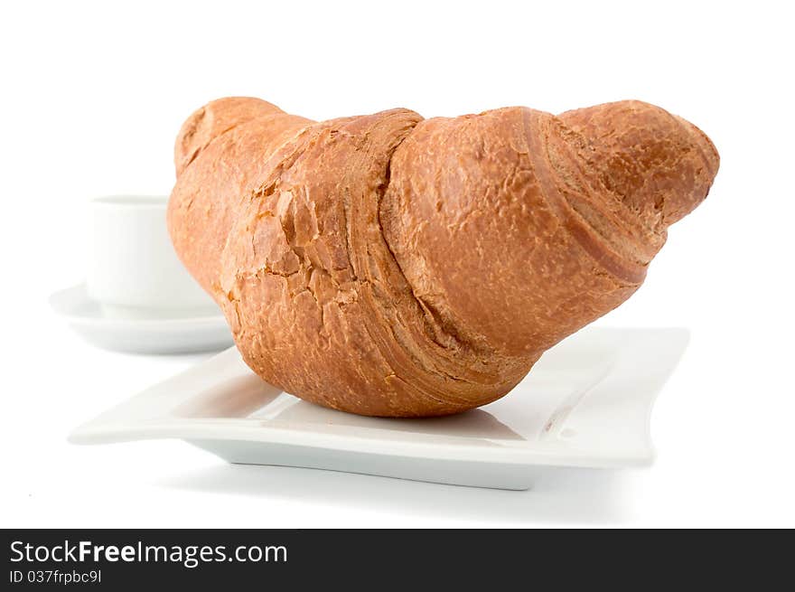 Croissant on a white plate on white background