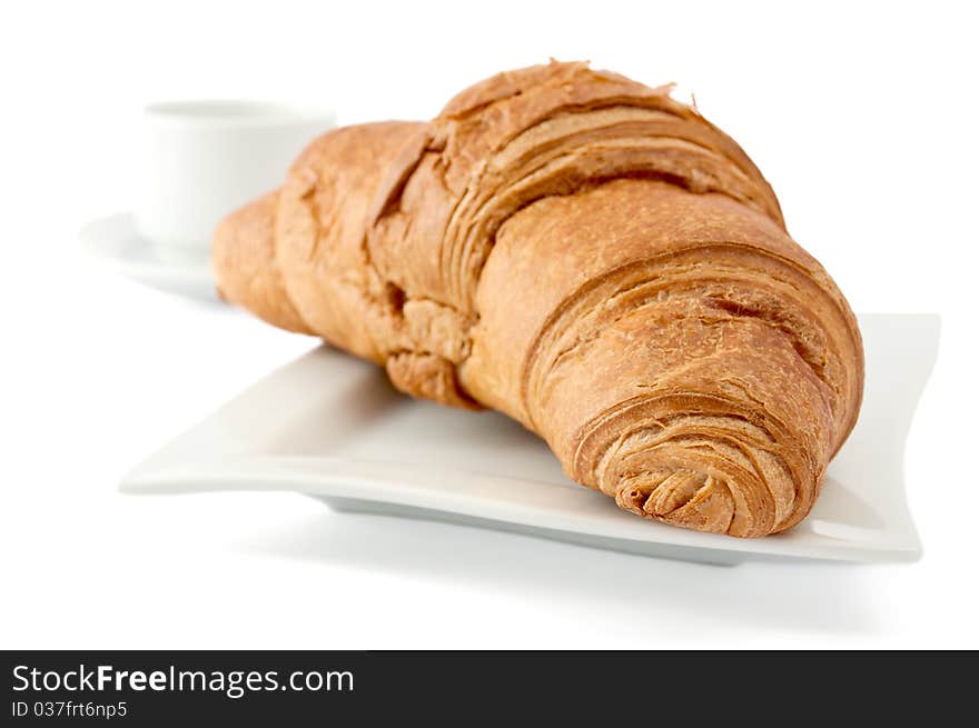 Croissant on a white plate on white background