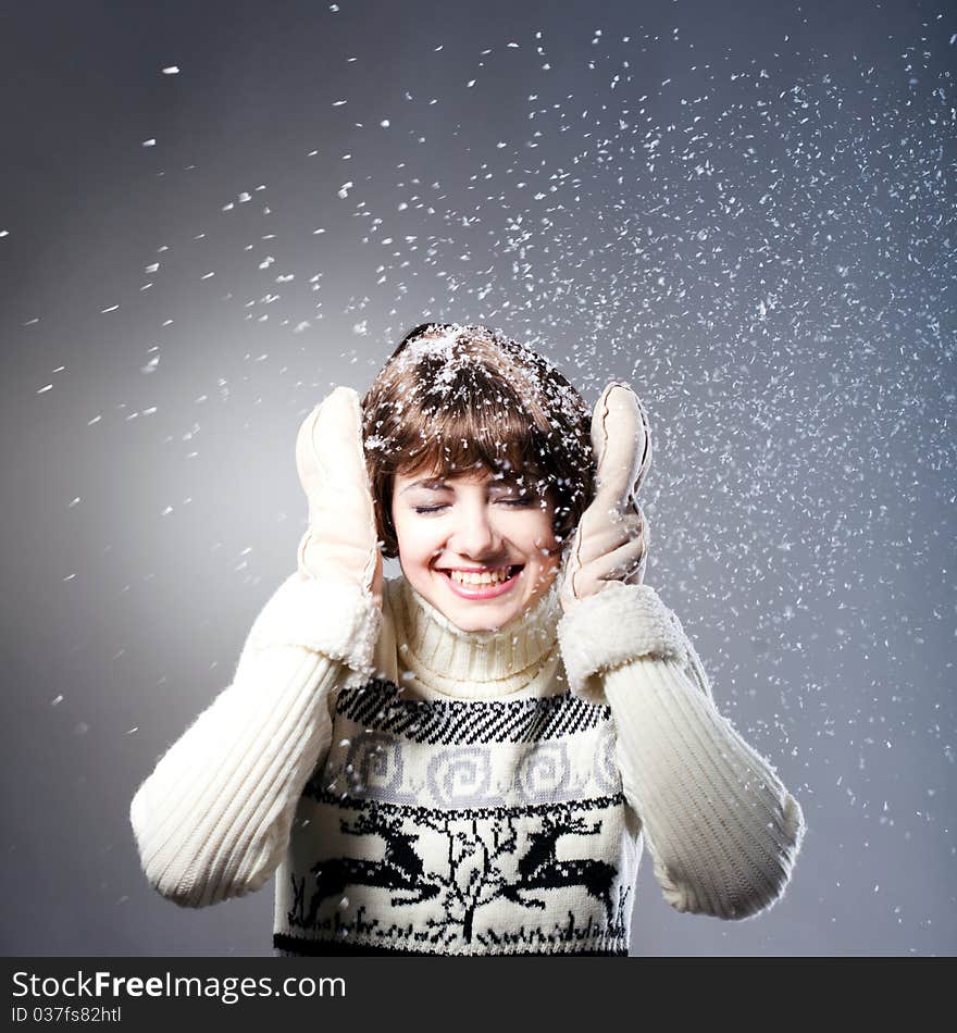 Young beautiful girl rejoices to snow, On a dark blue background