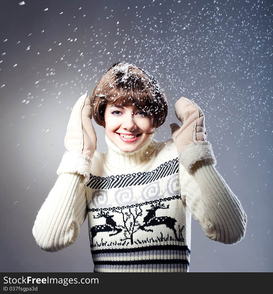 Young beautiful girl rejoices to snow, On a dark blue background