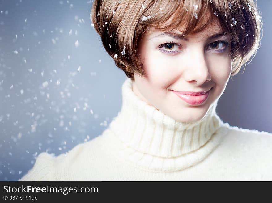 Young beautiful girl rejoices to snow, On a dark blue background