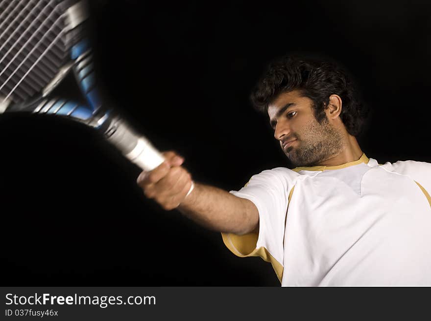 Tennis player playing a fore hand shot.