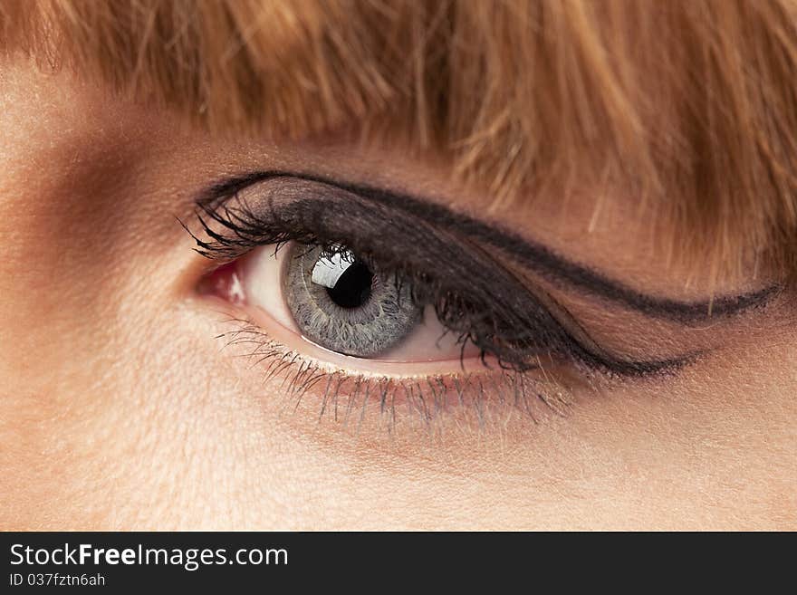 Close-up of woman eye with ceremonial bright make-up