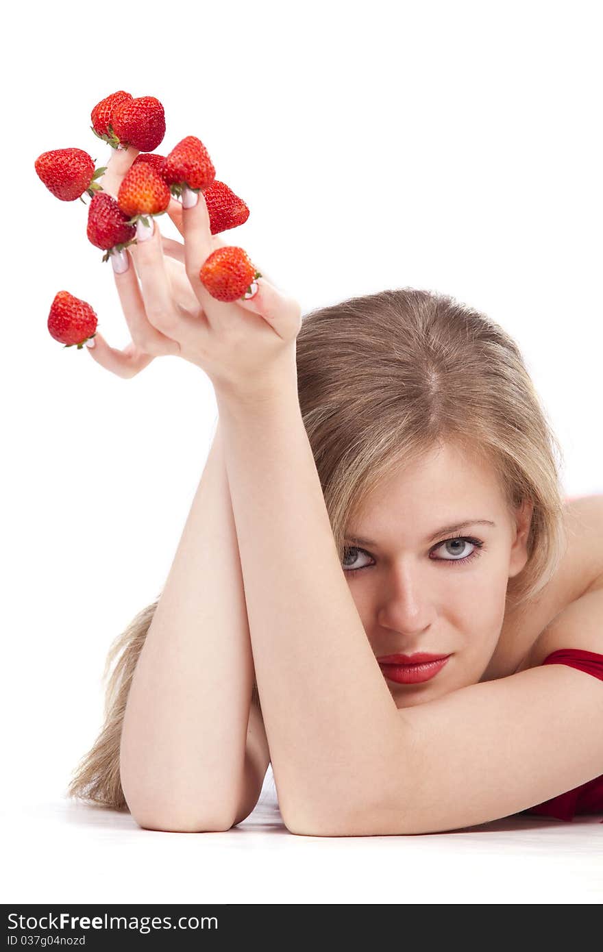 young woman with red strawberries picked on fingertips isolated on white background