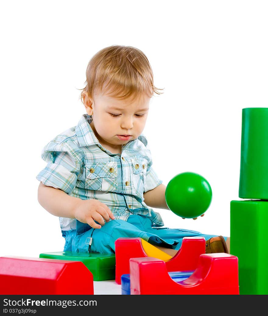 Cute little baby boy with colorful building blocks isolated on white