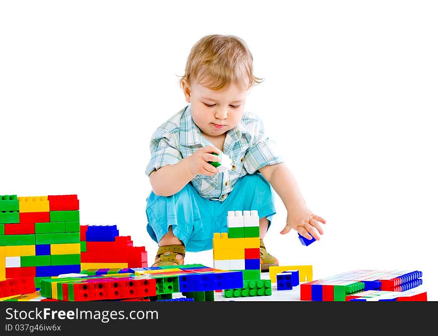 Cute little baby boy with colorful building blocks isolated on white