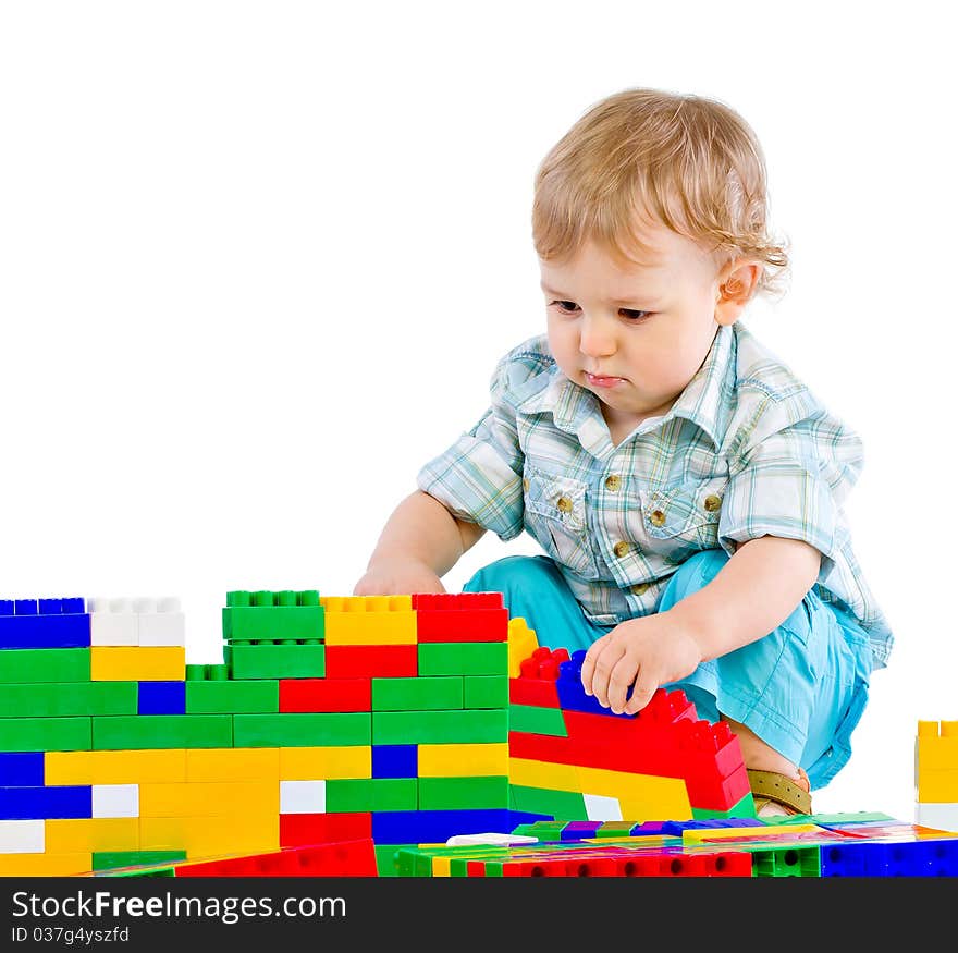 Cute little baby boy with colorful building blocks isolated on white