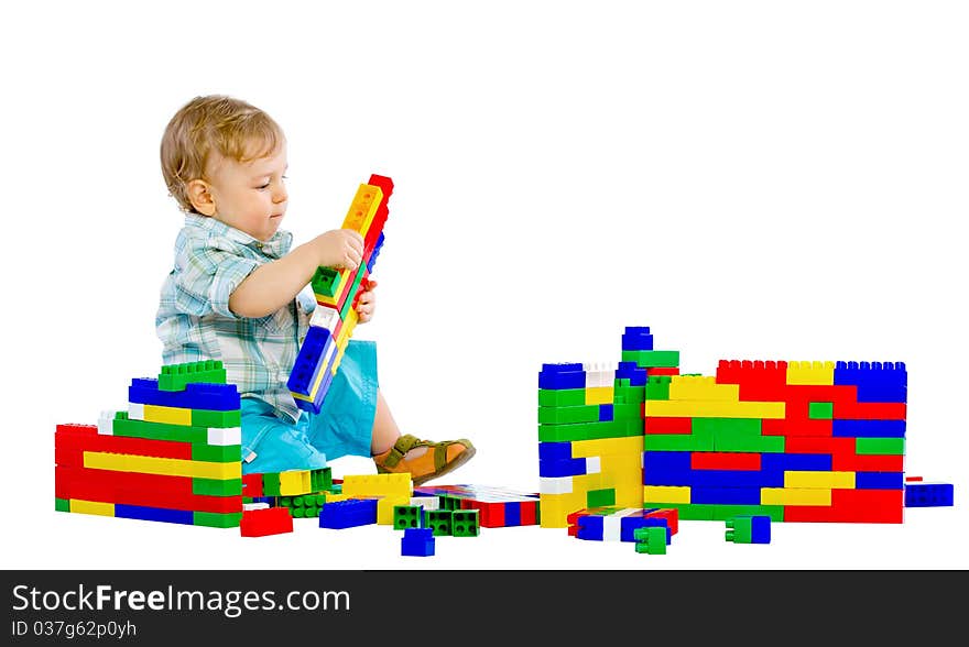 Cute little baby boy with colorful building blocks isolated on white