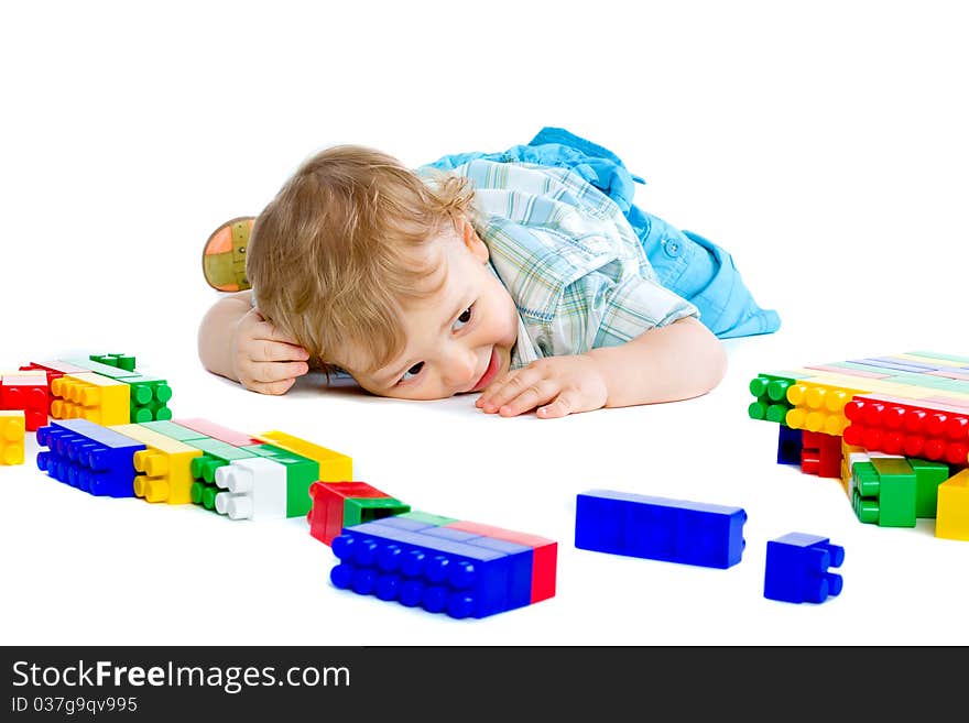 Cute little baby boy with colorful building blocks isolated on white