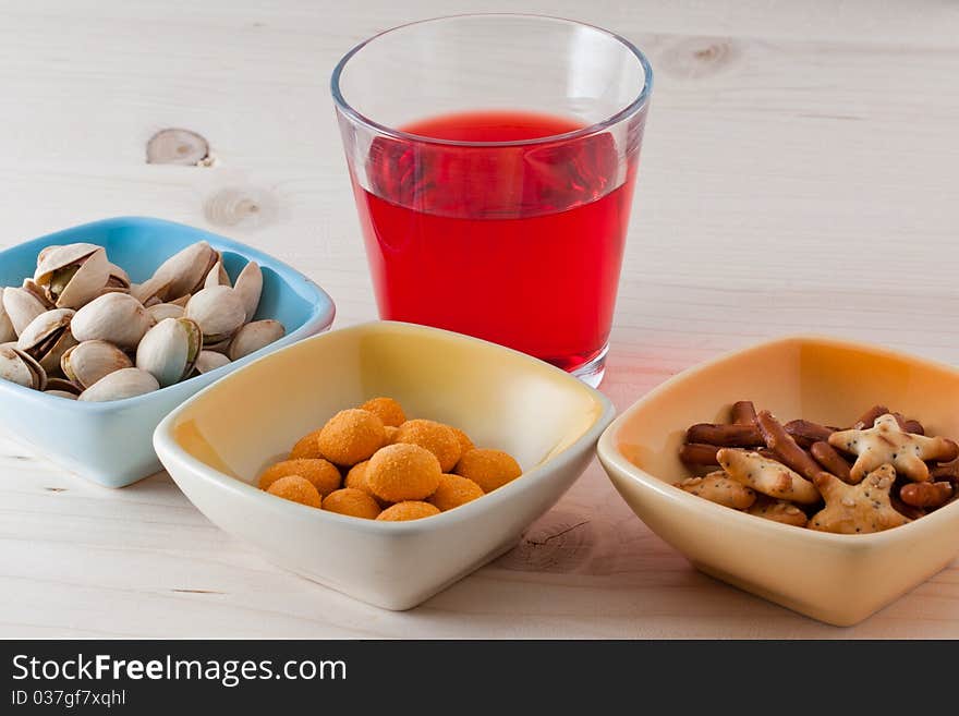 Mixed pretzels and red drink. Mixed pretzels and red drink