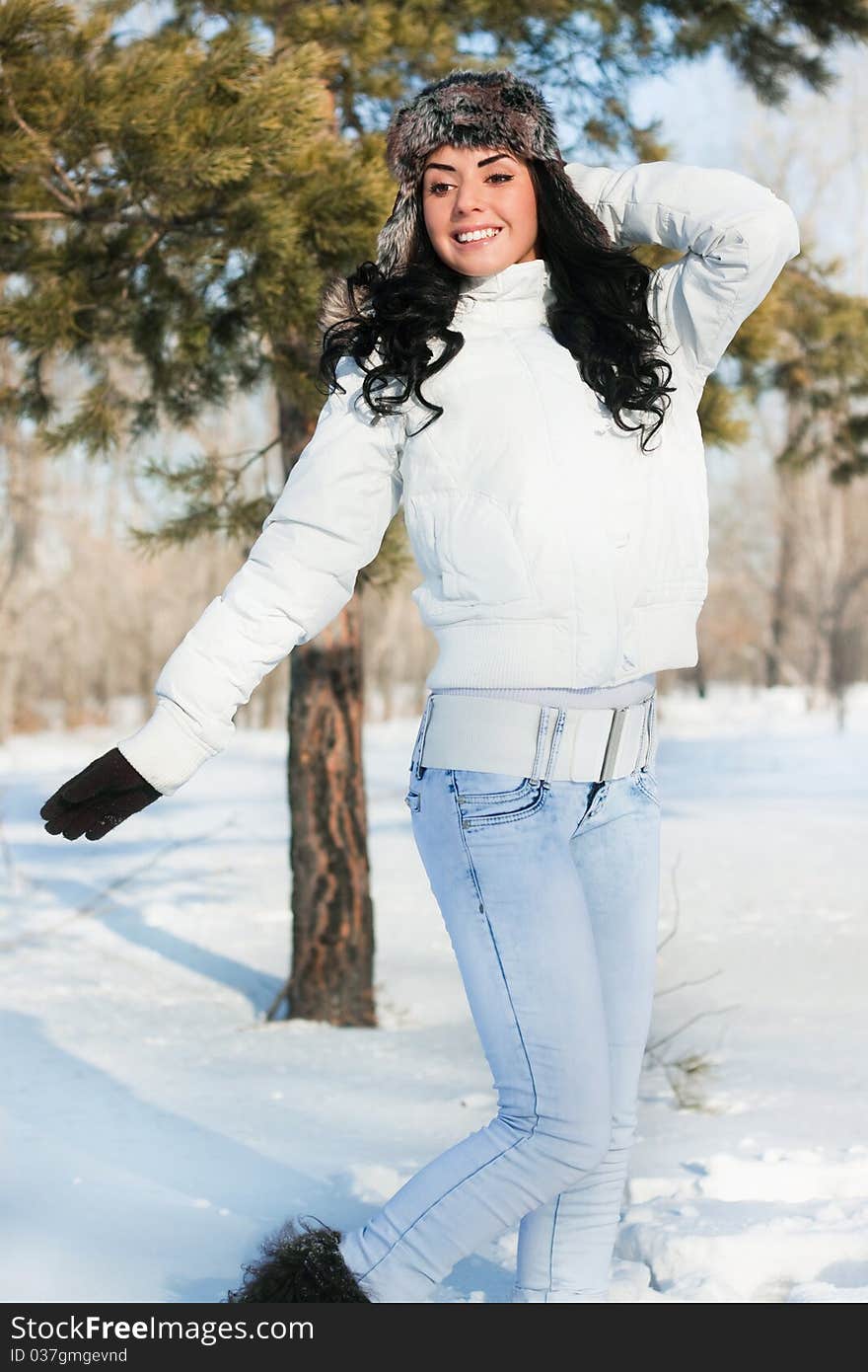 Beautiful girl on a walk in a winter park