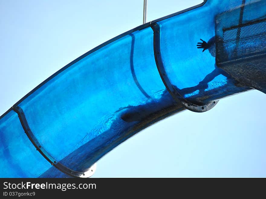 Young men in a blue waterslide. Young men in a blue waterslide