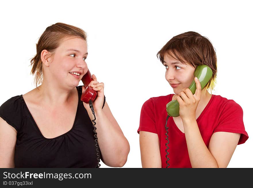 Two young women telephoning - isolated. Two young women telephoning - isolated