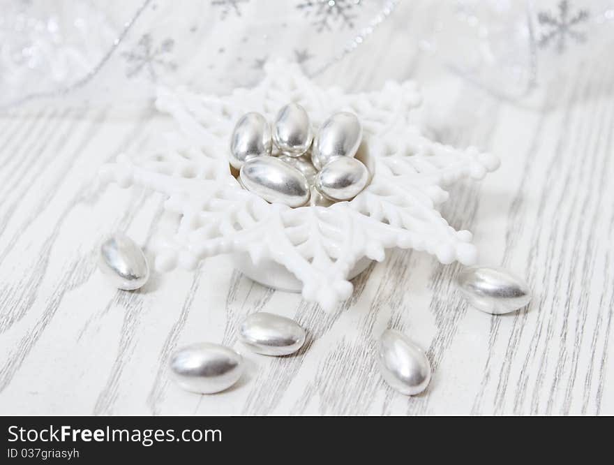 Silver Pistachio Candy on the white wooden background