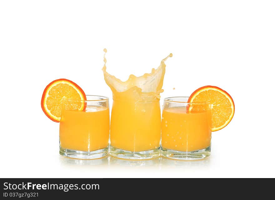 Three glasses of orange juice and fruits isolated on white background with clipping path. Three glasses of orange juice and fruits isolated on white background with clipping path