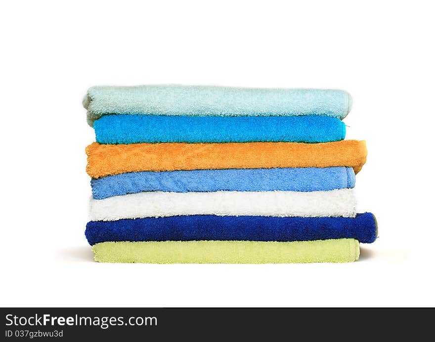 Stack of clean colorful towels isolated on white background. Stack of clean colorful towels isolated on white background