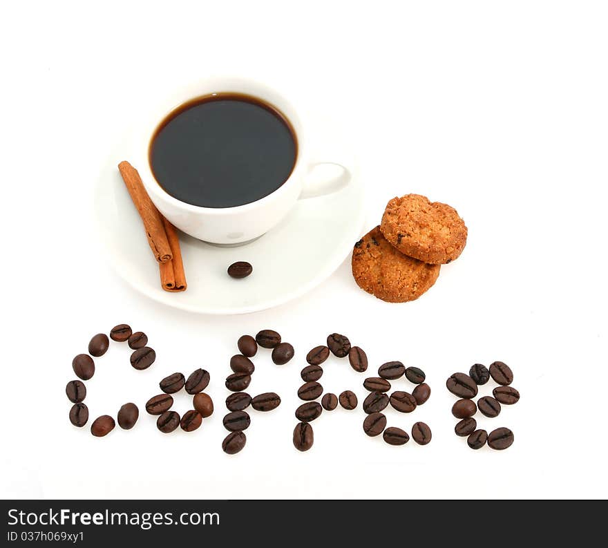 White coffee cup with cinamon sticks, cookies and a text written with coffee beans. White coffee cup with cinamon sticks, cookies and a text written with coffee beans