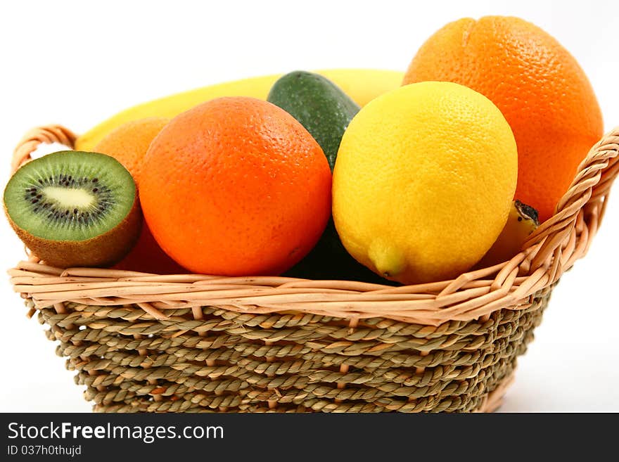 A basket full of exotic fruits - closeup - isolated on white. A basket full of exotic fruits - closeup - isolated on white