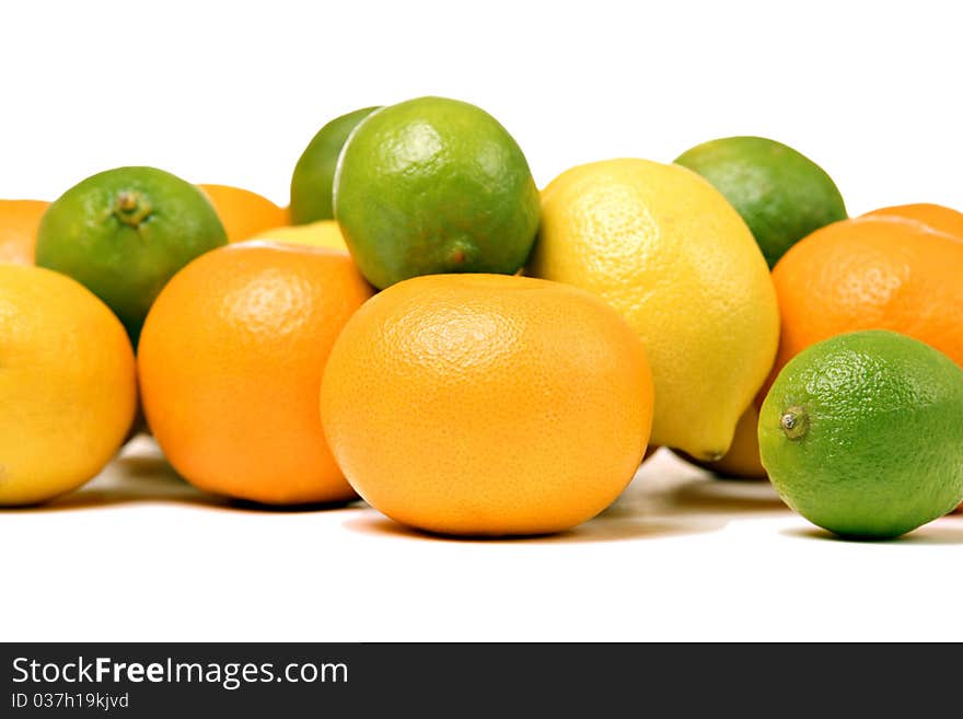 Whole oranges, lemons and limes, isolated on white