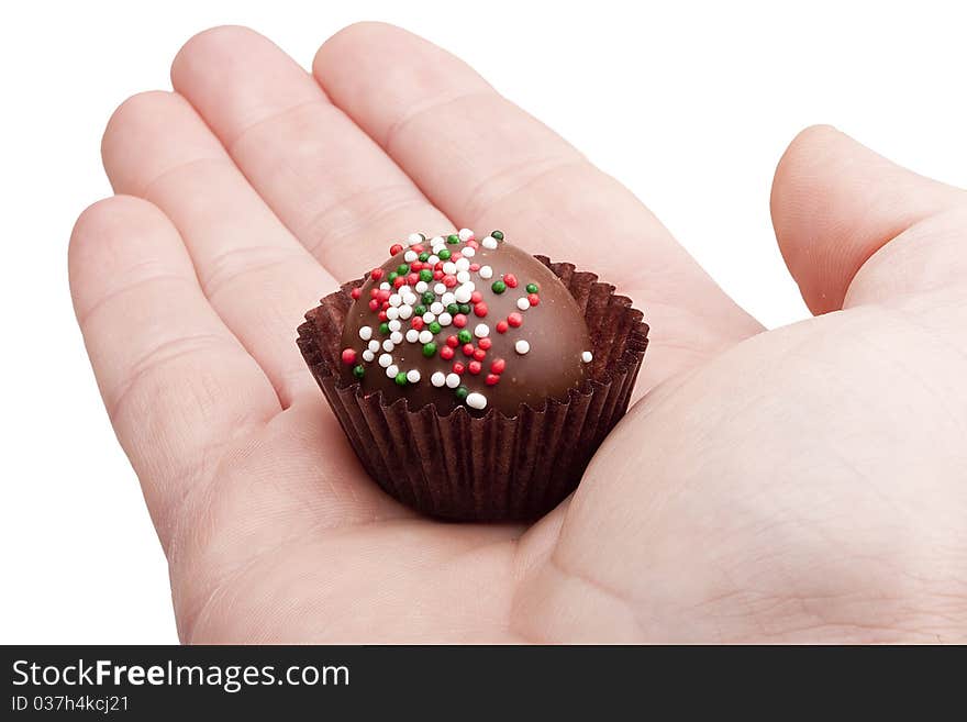 Candy cane from the gift set in a man's palm.