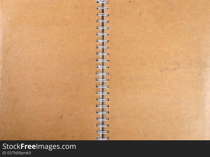 Blank grungy spiral cardboard notebook. Blank grungy spiral cardboard notebook