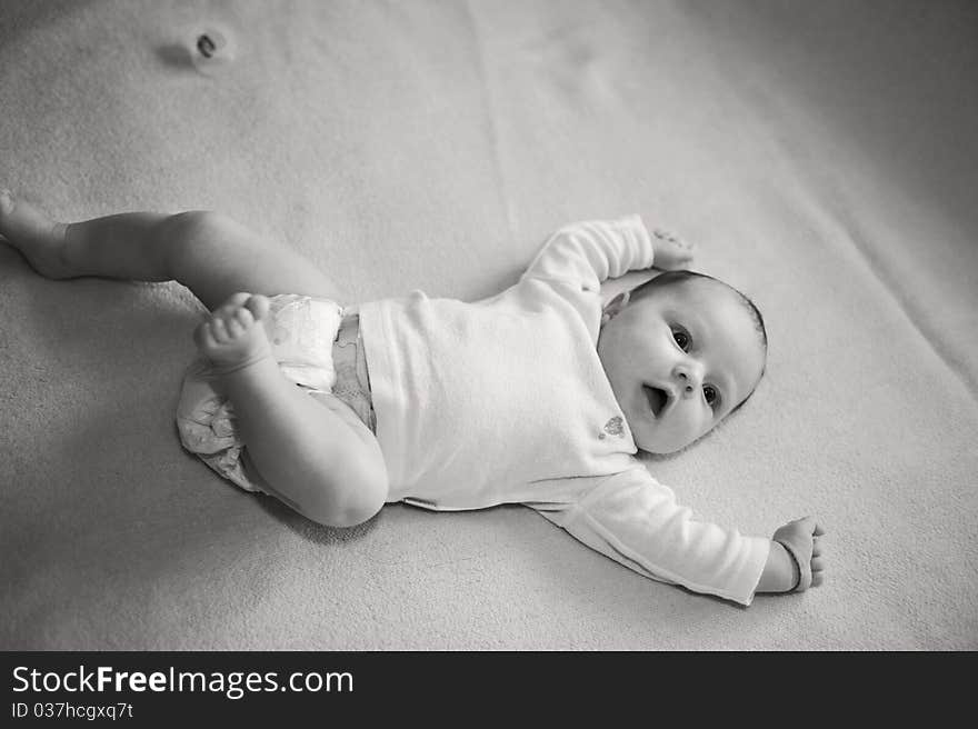 Portrait with little baby girl laying down on blanket