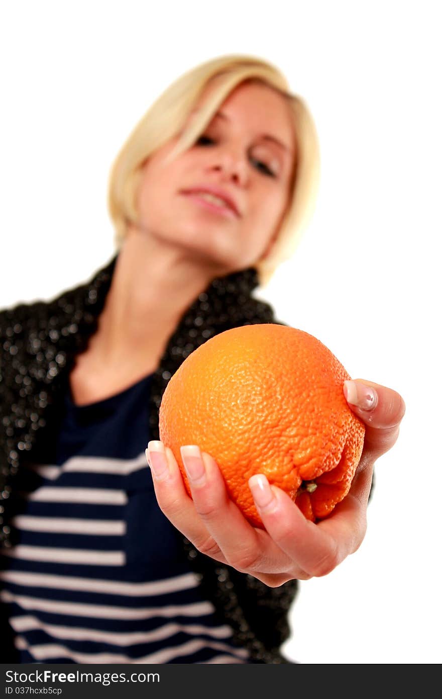 An blond girl passing an orange. An blond girl passing an orange