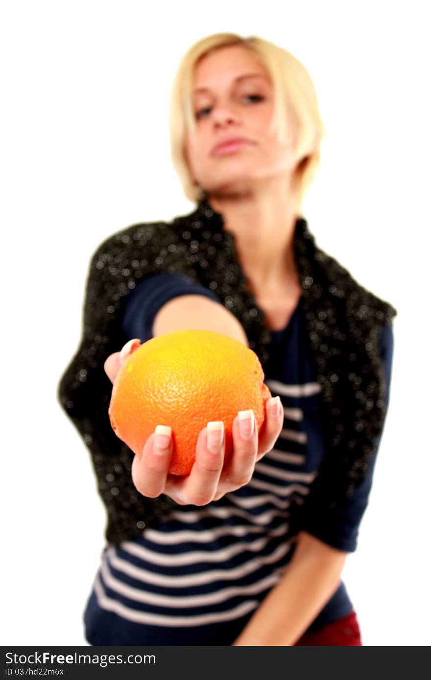 An blond girl passing an orange. An blond girl passing an orange