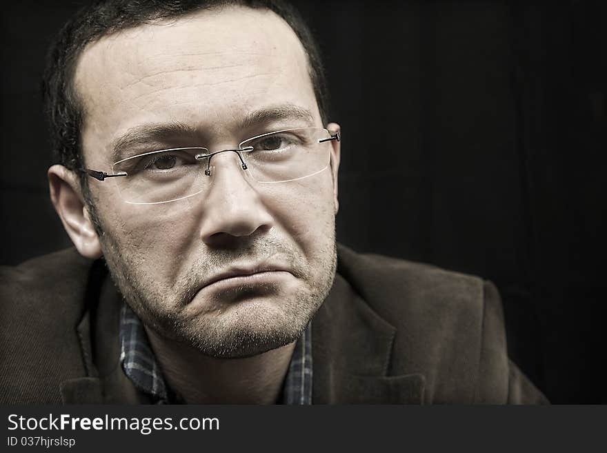 Portrait of a man, isolated over black background. Portrait of a man, isolated over black background