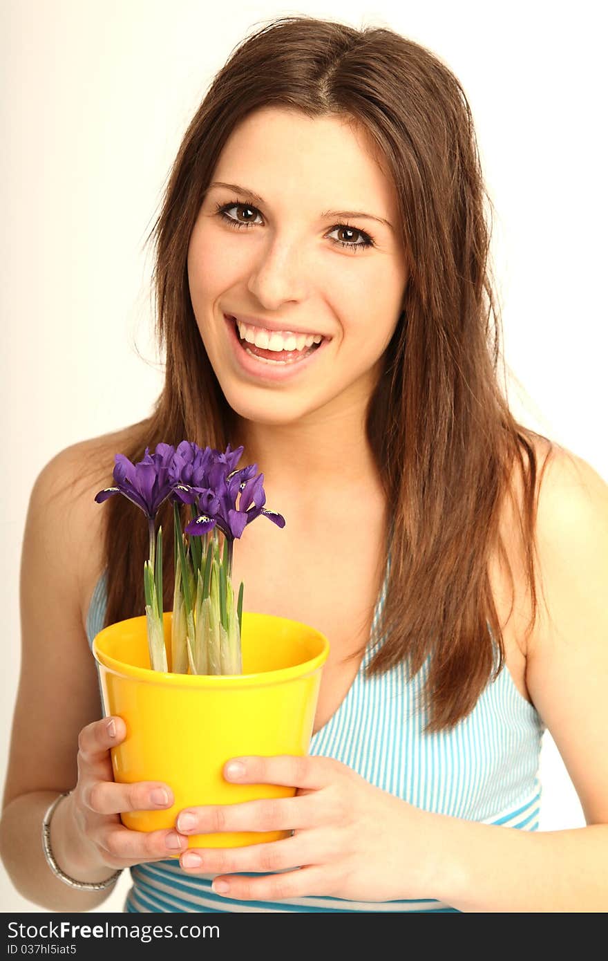 Beautiful brunette girl with fresh flowers in a flowerpot. Beautiful brunette girl with fresh flowers in a flowerpot