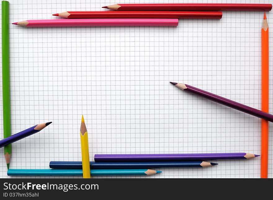 Colorful pencils frame on blank paper sheet