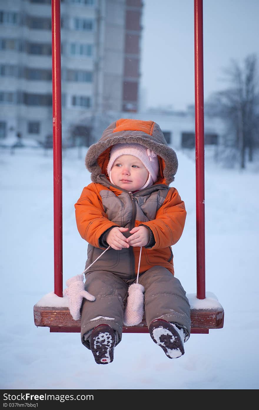 Cute Baby Sit On Swing On Playground