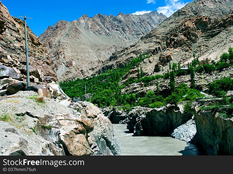 A rough mountains with a stones and boulders with a lake flowing in. A rough mountains with a stones and boulders with a lake flowing in.