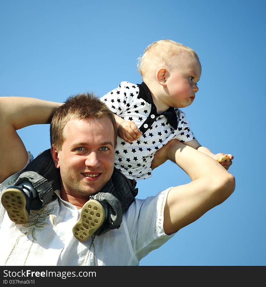 Father and son in blue sky