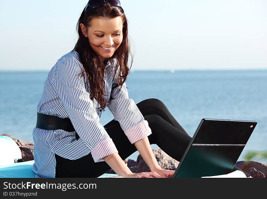 Woman with laptop sea background. Woman with laptop sea background