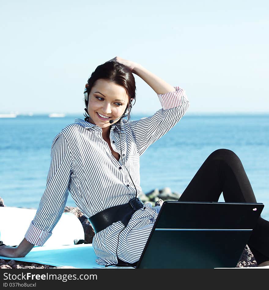 Woman with laptop sea background. Woman with laptop sea background