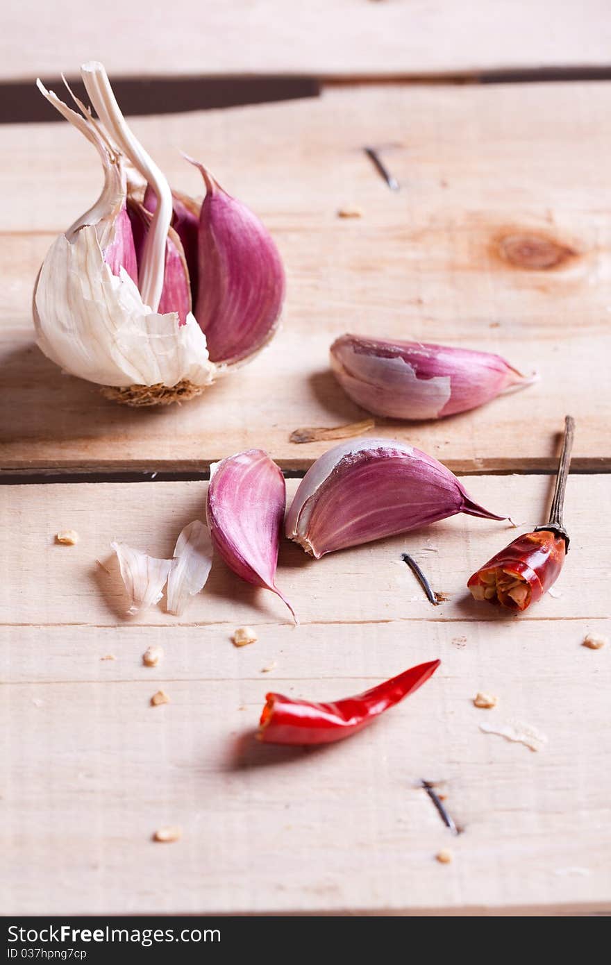 Garlic and dry red pepper on old wooden desk. Garlic and dry red pepper on old wooden desk