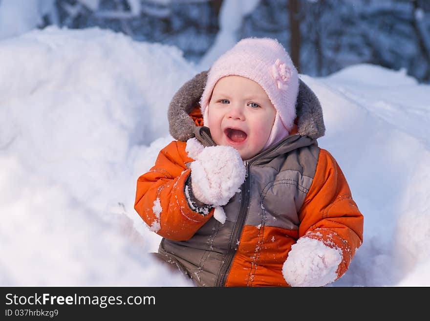 Adorable baby try to eat cold snow