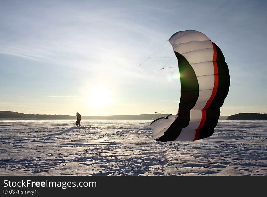 Paraglider silhouette sundown blue sky background