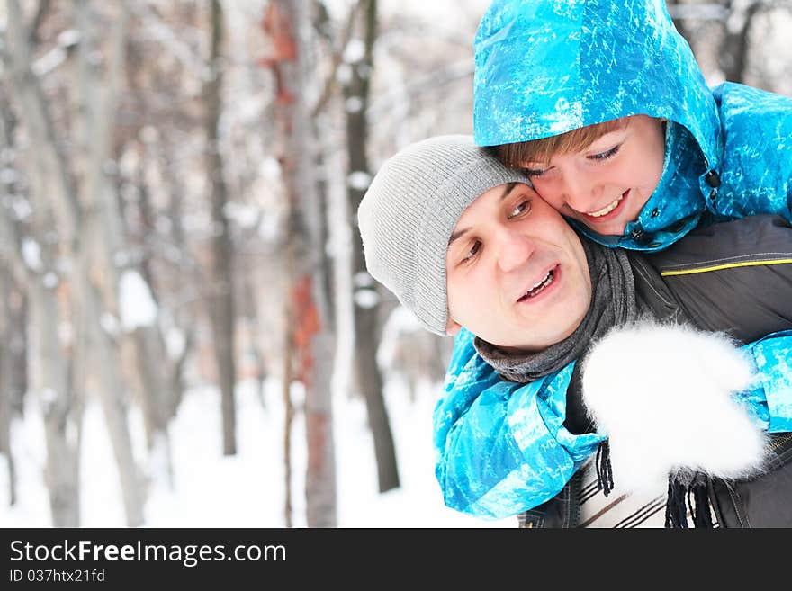 Young playful couple has a fun. winter