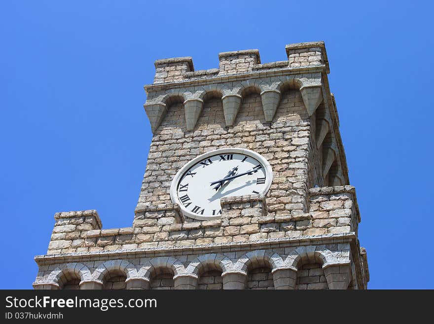 A Venetian style Clocktower against clear blue sky