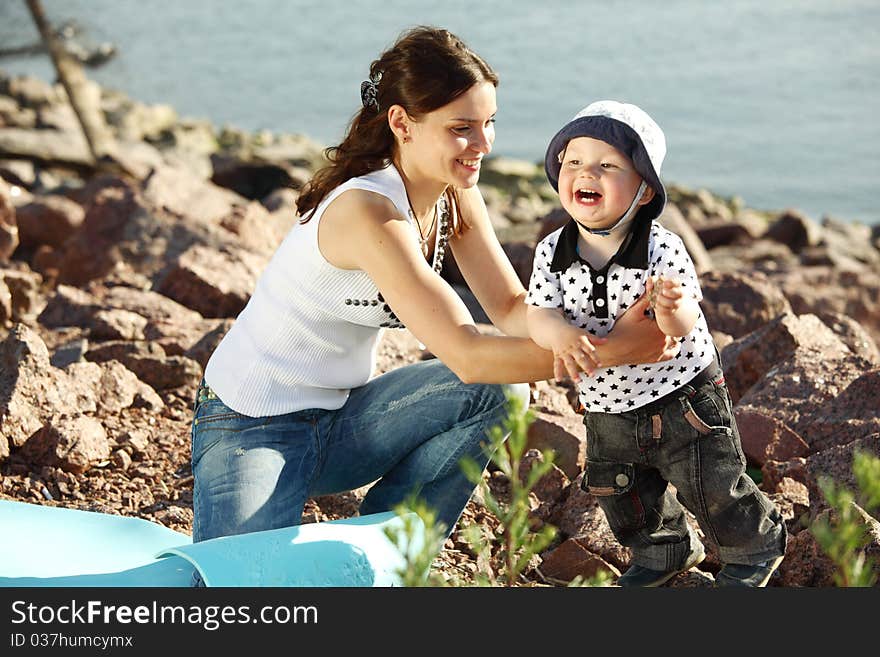 Happy mother and son on picnic near sea