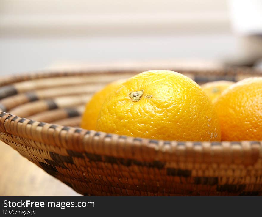 Oranges in a basket view from the side